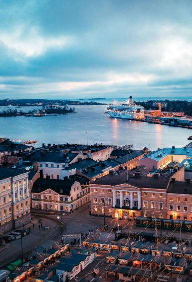 Aerial view from above Helsinki Cathedral, with the Senate Square in the frame, looking out towards Helsinki harbour in the evening 