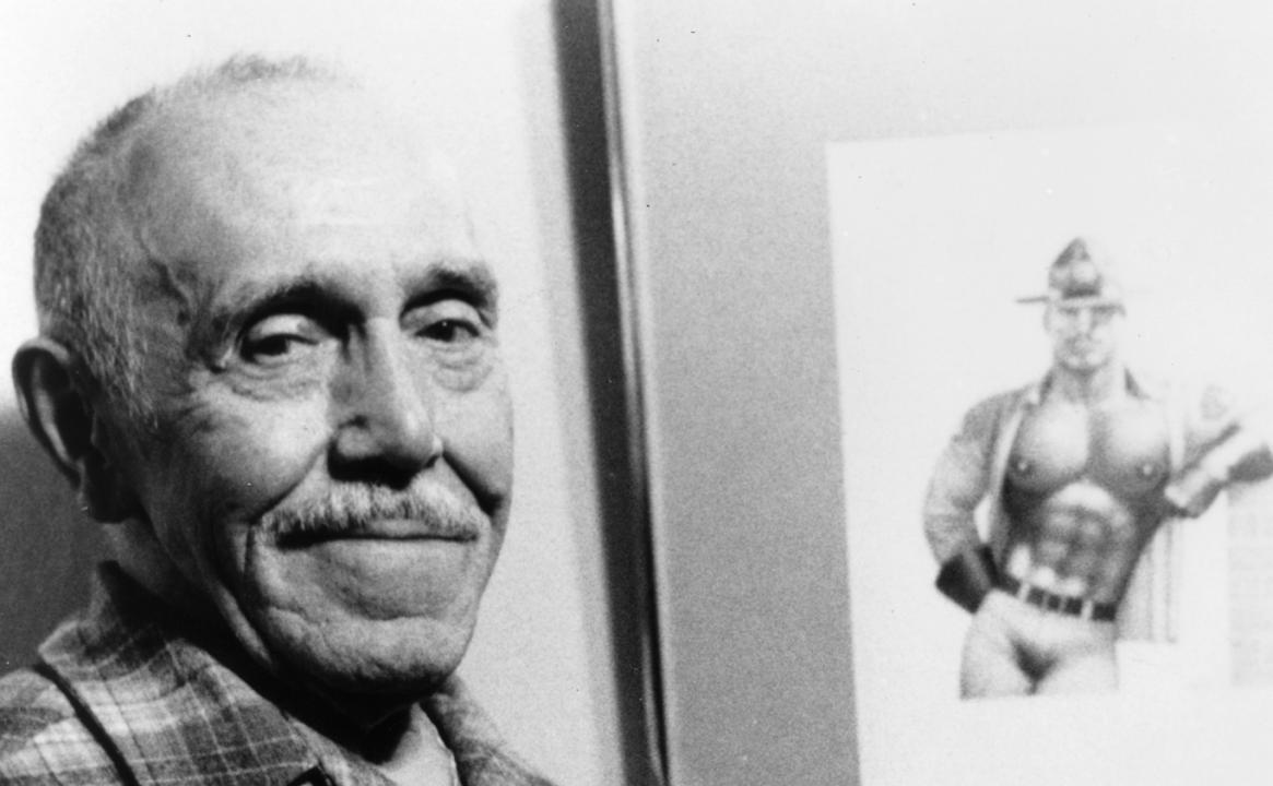 Black and white portrait photo of an older Tom of Finland next to one of his illustrations, a shirtless fireman.