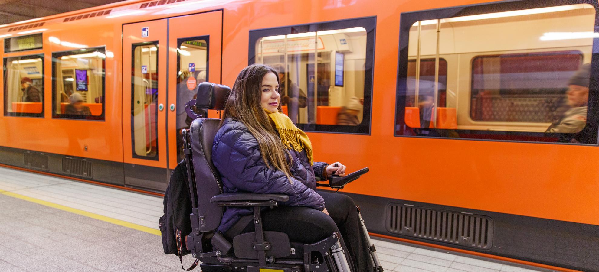 Woman with a wheel chair at the metro station