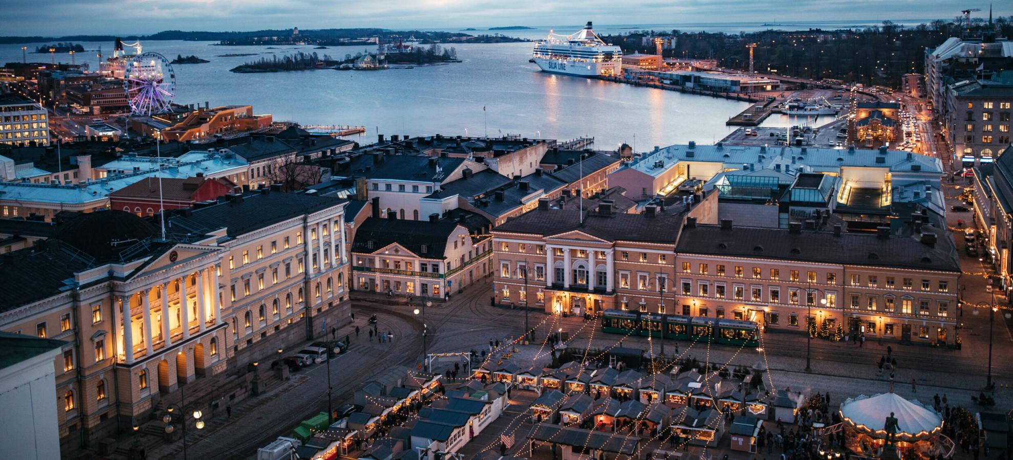 Aerial view from above Helsinki Cathedral, with the Senate Square in the frame, looking out towards Helsinki harbour in the evening 