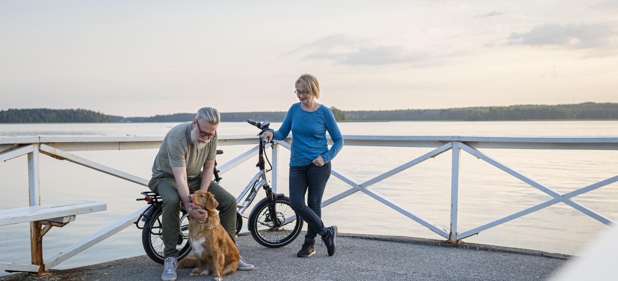 Couple with a dog on a pier